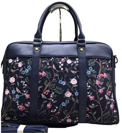 Navy bag with colorful leaf pattern on a white background