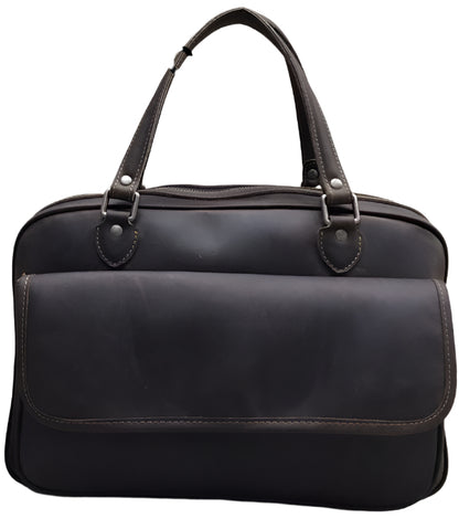 Black leather handbag with measurements on a wooden background