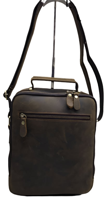 Brown leather crossbody bag with multiple zippers on a white background