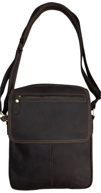 Brown leather crossbody bag on a light wood background