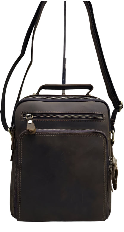 A brown genuine leather sling bag displayed from multiple angles, highlighting the bag's design and zipper detailing.