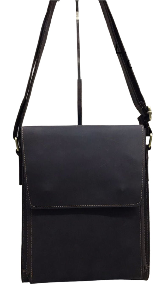 A brown genuine leather sling bag with a front pocket and a shoulder strap, displayed in two different angles.